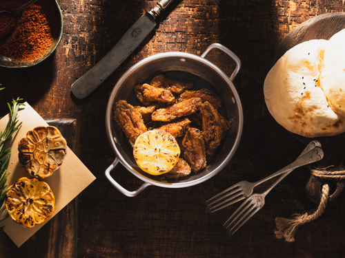 Chicken Wings with Pomegranate - Fresh Fried Chicken Wings with Coriander, Pomegranate Molasses, Luxurious Flavors, and Lemon.