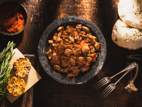 Ras Asfour with Armenian Tomatoes - Dice of Beef Fillet. Dipped with Flavoring and Armenian Tomato Sauce. Prepared In Hot Pottery.