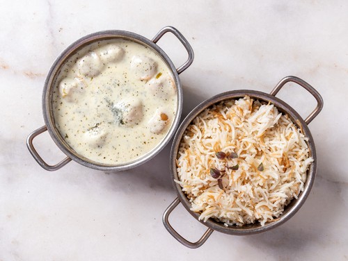 Shish Barak - Pieces Of Dough Stuffed  Meat Dipped in Yougart (Laban), Cooked on Maya'rs Special Recipe. Served with White Rice.