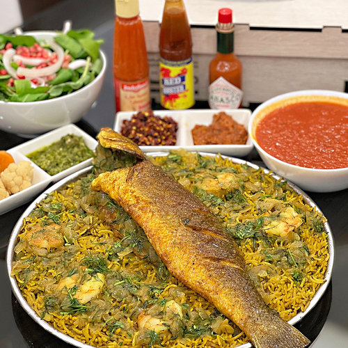 Sea bass monasabat - Fried sea bass with shrimps and bread. Served with green and red maboj and kuwaiti ajar, and mango ajar.