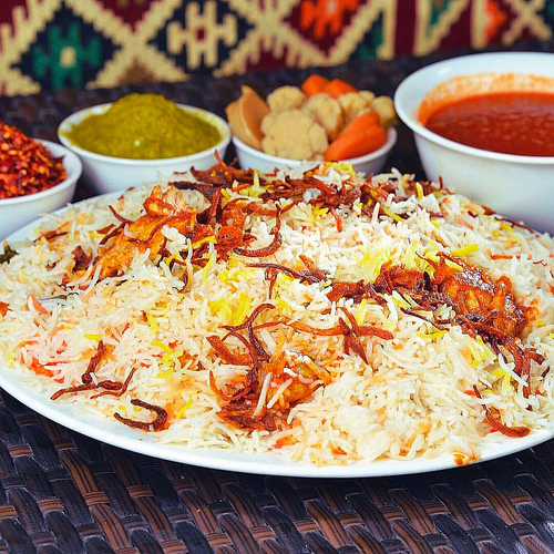 Australian Meat Biryani - Basmati bread cooked with meat broth, ghee, cardamom, spices and saffron, served with cold australian beef with sauce, potato broth, agar and mabouj.