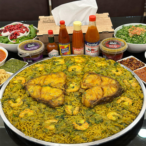 Hummour Specials - Two pieces of hamour fish with shrimp, fish rice, green and red maabouj, pickles and broth