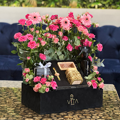 Haya - A black box contains gerbera, baby roses and greens with a box  contains mubkhar, charcoal tweezer, bokhour empty box, home fragrance and chocolates.  Note : you can add bakhour if you need  Height: 55 Width: 35