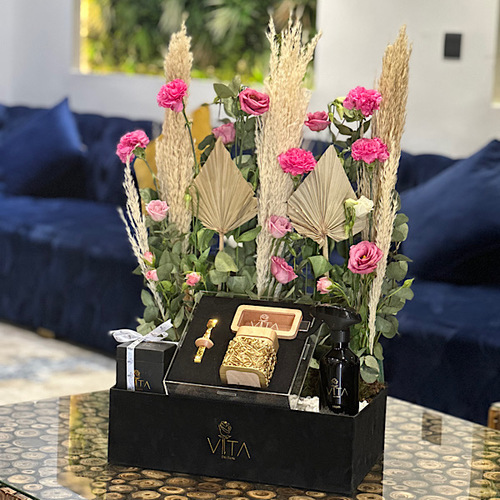 Surface - A black box contains pink carnations and purple eustoma with a box of mubkhar, charcoal tweezer, empty box for bokhour, home fragrance and chocolates. Height: 55 Width: 35