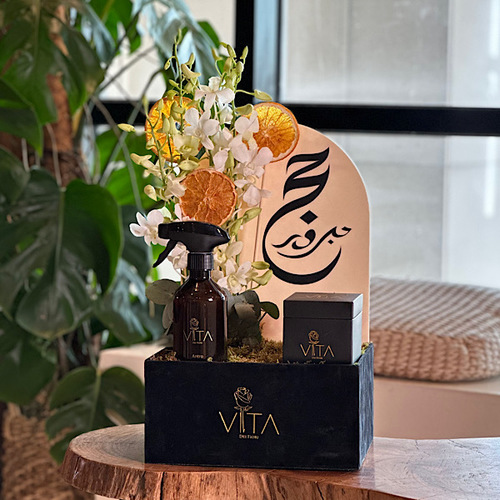 The Road - Black box contains white baby orchid, dried fruit, with box of chocolate and spray perfume. Height: 50 Width: 20