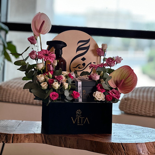Hold - Black box contains pink anthurium, pink, fuchsia roses, green leaves, with box of chocolate and spray perfume. Height: 65 Width: 20