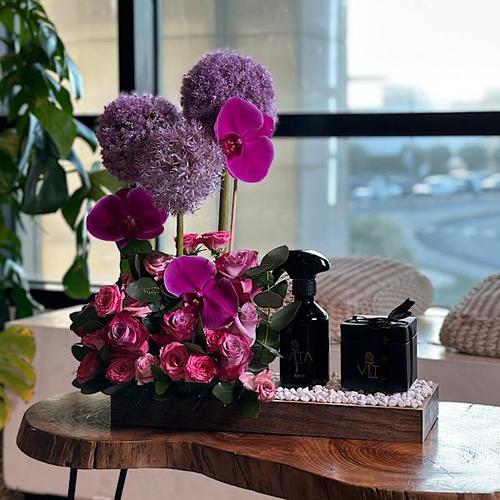 sofina - wooden tray contains purple orchids, elliom , green leaves pink , fucia baby roses with spray purfume and box of chocolate Height: 50 Width: 30