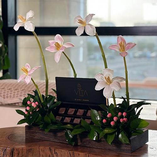 martin - A wooden tray that contains pink , white tulip, hypericum pink  ruscus leaves box of chocolates. Height: 35 Width: 30