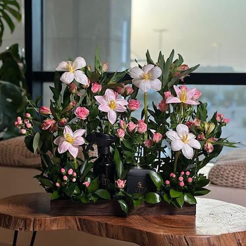 ema - A wooden tray that contains pink, white tulip, hypericum pink baby roses pink astomeriya pink ruscus leaves with spray perfume and a box of chocolates. Height: 35 Width: 30