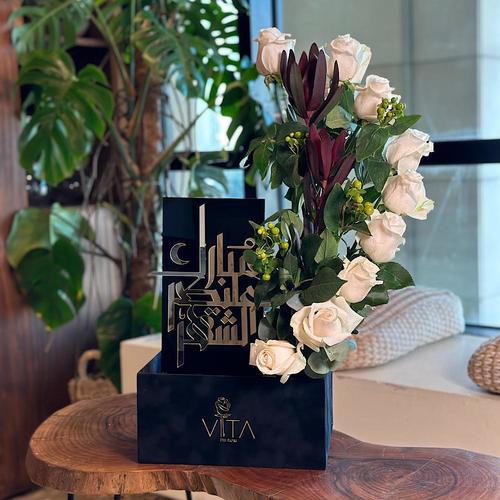 Towering - Black box contains white roses green leaves with green hypericum and Ramadan stand Height: 50 Width: 20