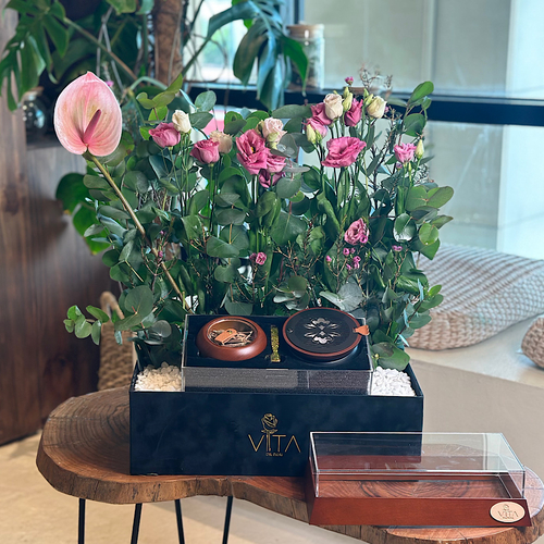 Wed - A black box that contains pink anthrium, green leaves, purple eustoma with a middle acrylic box containing mubkhar and charcoal handle with an empty box for  Height: 65 Width: 40