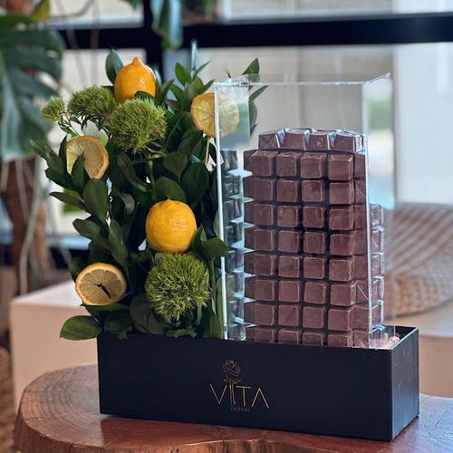 LODI - Black
box contains green ruscus ، fresh
lemon and tower of chocolate with 72 chocolate pieces    Height: 50   



 Width: 30