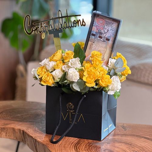 Lucky - A black bag contains baby roses with a cash gift box, and congratulations topper. Note: the cash is not included. Height: 18 Width:15