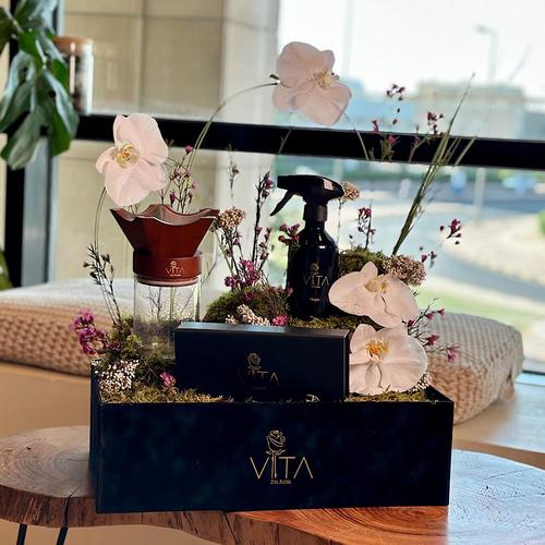 Marvellous - A black box that contains white orchid, steel grass, wax flower, raish flower, and flat mouse green with mubkhar with an empty space down to place the bakour, with spray perfume and chocolates. Height: 50 Width: 40