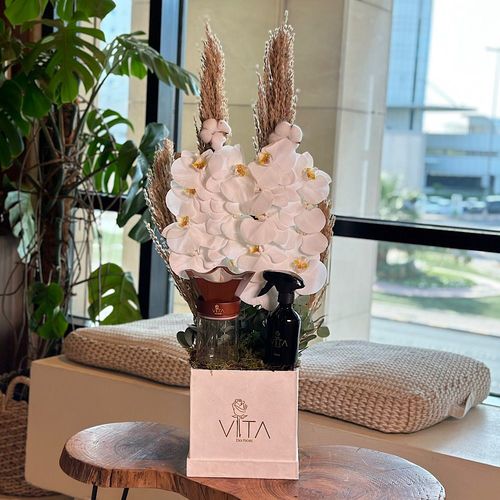 Elsa - A white box contains white orchid cut and green leaves with mubkhar with an empty bokhour and home fragrance. Height: 50 Width: 20