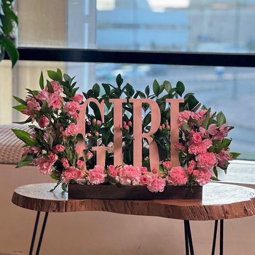 Eirlys - A wooden tray contains baby roses pink carnations pink astomeriya pink, Hypericum pink ruscus green acrylic stand girl new born Height: 50 Width: 35