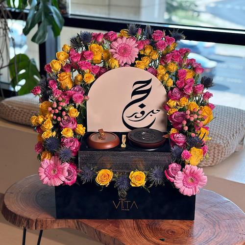 Awesome - A black box that contains roses, baby roses, hypericum, gerbera, eryngium and eucalyptus with acrylic Haj stick & box filled with mubkhar, charcoal and an empty bokhour storage box. Height: 50 Width: 40