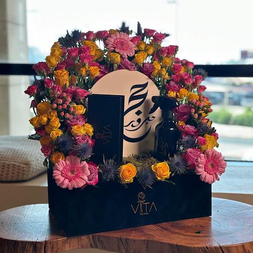Stardust - A black box contains roses and baby roses, hypericum, gerbera, eryngium and eucalyptus with acrylic Haj stick & spray perfume with box of chocolate Height: 50 Width: 40