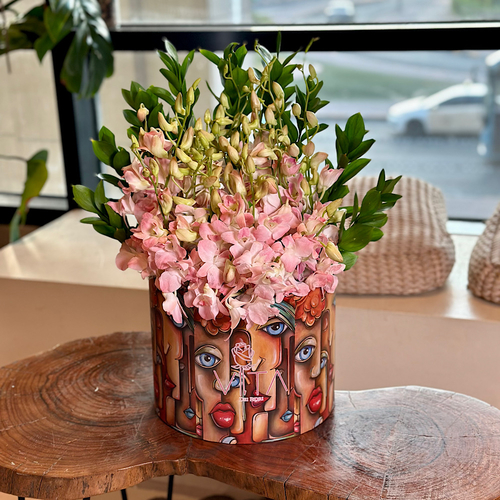 Lopk - A round box contains pink baby orchid, and green leaves. Height: 56 Width: 25