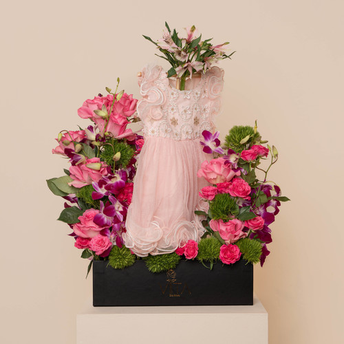 The Trendy - This box contains pink roses, baby roses, and green leaves with newborn dress. 
 H : 70 
 W: 40