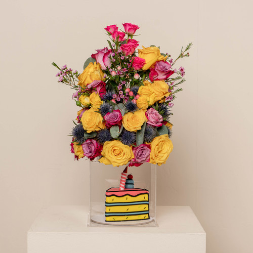 fanar - acralic box contains yellow roses green leaves purple roses with cake H: 40 
 W 20