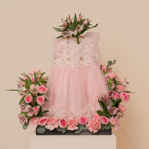 centro - black base contains pink carnations pink baby roses green leaves astoromiroa pink with newborn dress 
 H 75 cm W :35