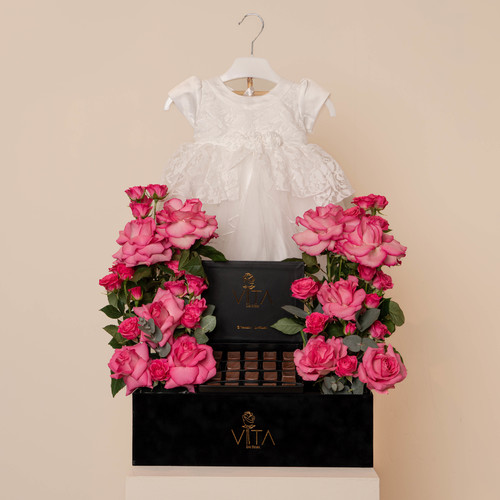 the desire - black box contains fucia roses fucia baby roses green leaves with middle box of chocolate and newborn dress 
 H: 75 cm 
 W: 40 cm