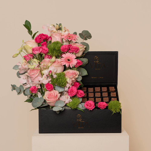 source - black box contains pink baby orchids green leave pink roses fucia baby roses pink grabera with mubkhar box of chocolate 
 H: 55  
 W 40