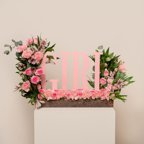 gryzli - A wooden tray contains baby roses pink carnations, pink astomeriya, an acrylic stand for a girl new born. Height: 50 Width: 35