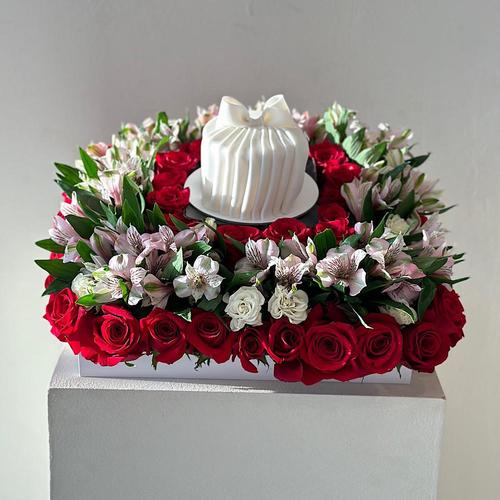 Peru - A black base containing red roses, alstromeria pink, with a cake. Height: 35  Width: 30