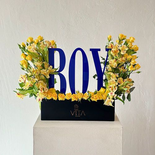 Ocean - A black box contains baby roses yellow  astomeriya yellow , an acrylic stand for a boy new born. Height: 50 Width: 35