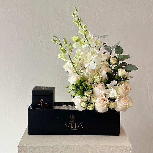 Iro - A black box contains roses and baby orchids with a box of chocolates  Height: 45 Width: 35