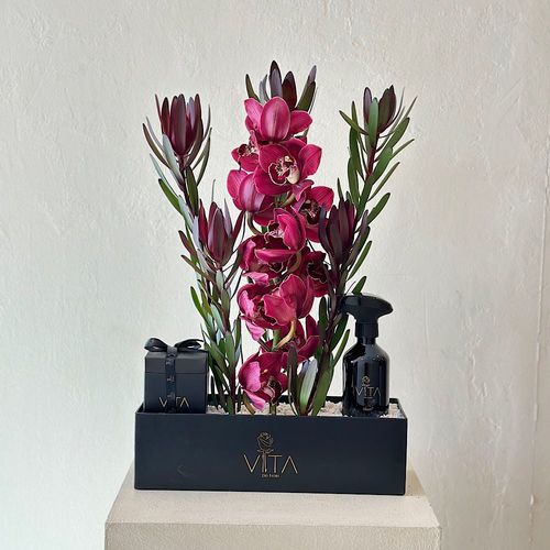 Yuppie - A black box contains purple cymbidium and safari sunset with home fragrance and a box of chocolates. 
 H: 60  W: 40