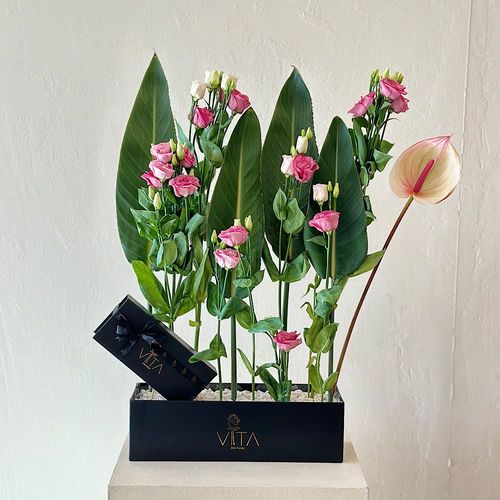 Martira - A black box  that contains pink anthurium, green leaves, purple astoma, and a box of chocolates.  
 H : 60 W : 40