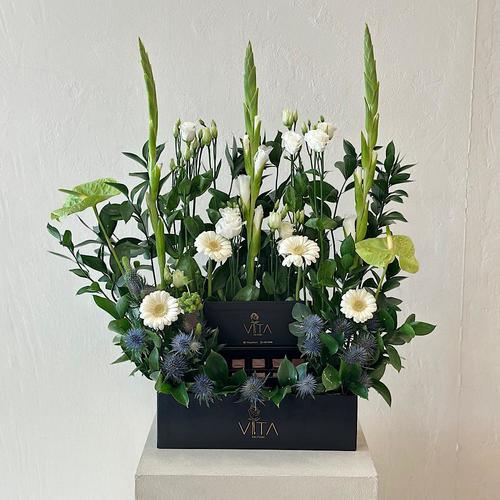 lama - black box contains green antuiom , white grabera , green leaves and baby roses white with box of chocolate 
 H 60 w 30