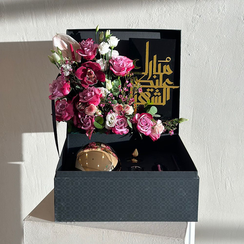 Crown - Black box that contains deep purple roses,baby rose pink,white estoma , waxflower, cymbidium, anthurium ,green leaves, and with a diffuser 250 ML . Height: 50  Width: 40