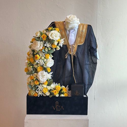 Mures - A box filled with white roses, baby roses, chrysanthemums, carnation, hypericum and greens with a baby dishdasha, baby bisht and a box of chocolates. Height: 60 Width: 40