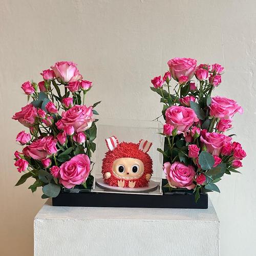 Dolj - A tray elegantly filled with pink and fusai baby roses, green leaves with a cake. Height: 50 Width: 20