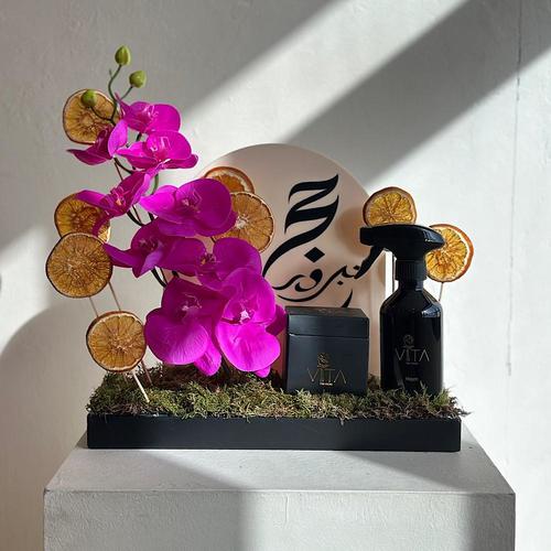 oref - A tray elegantly filled with orchids and dried fruits with a box of chocolates and a home fragrance spray. Height: 40 Width: 20