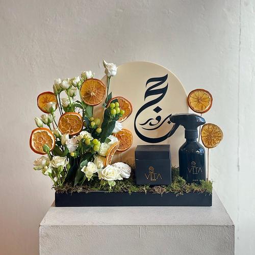 Hajer - A tray elegantly filled with white baby rose, hypericum green and dried fruits with spray perfume and box of chocolates. Height: 40 Width: 20
