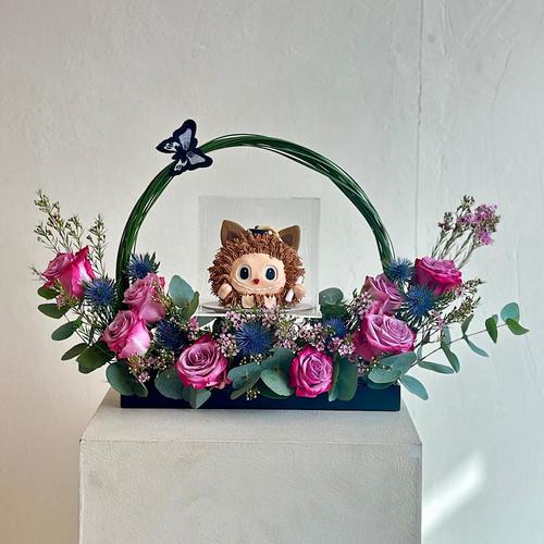 Valerian - A tray that contains steel grass purple roses green leaves eryngium with waxflower eucalyptus with a cake. Height: 50 Width: 20