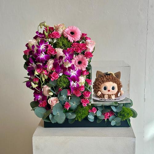 Zubac - A tray that contains roses and baby orchid purple dianthus gerbera pink eucalyptus with a cake. Height: 55 Width: 20