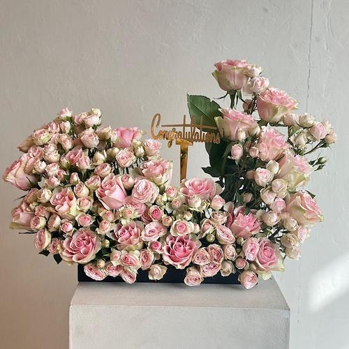 dana - A tray elegantly filled with pink roses and baby roses with girl topper a congrats gold stick.
Height: 60 Width: 20