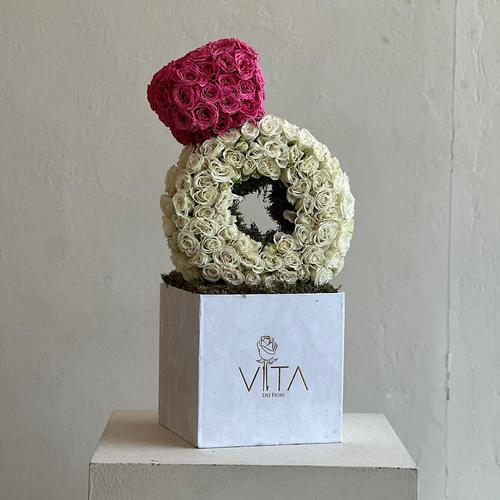 Mary - A white box contains ring shape with white baby roses and fuchsia
Height: 60
Width: 25