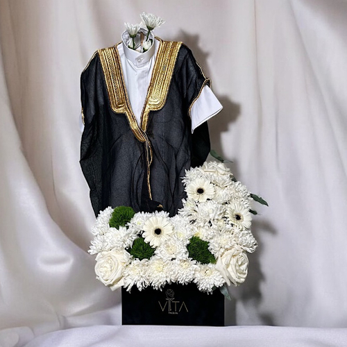 Petaldust - A black box contains white gerbera, white roses, chrysanthemums&nbsp; and greens stick , with&nbsp; new new baby born deshdasha and bisht Height: 50 Width: 20