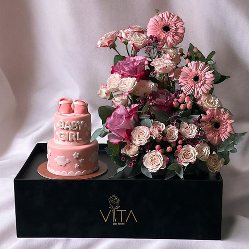 Bombshell - A black box contains deep purple roses, gerberas, pink and baby roses pink, wax flower, purple hypericum, pink and eucalyptus leaves. comes with a two layered baby girl cake. Height: 30 Width: 40