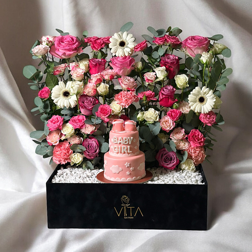 Cherish - A black box contains deep purple roses, pink roses gerberas, white and baby roses pink, baby roses fuchsia, baby roses white and eucalyptus leaves. comes with a two layered baby girl cake. Height: 50 Width: 40