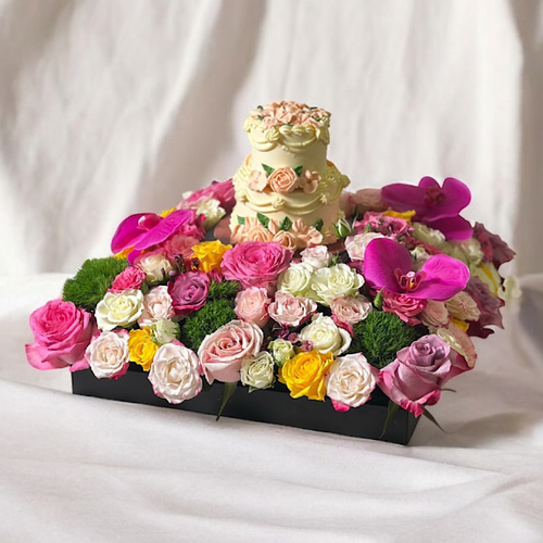 Stark - A black base that contains deep purple roses, yellow roses, pink roses, green stick, cut flowers purple Artificial, baby roses and leaves, comes with a two layered cake. Height: 25 cm Width: 40 cm