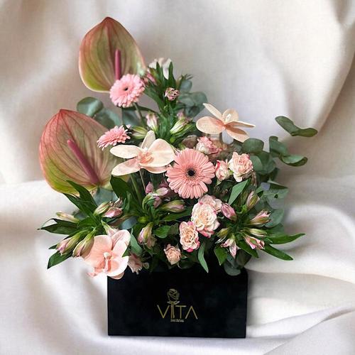 Wales - A black box containing baby roses, orchid, cut flower and anthurium, gerbera pink, alstroemeria pink and green leaves. Height: 40 cm Width: 20 cm