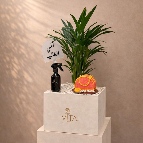 Golden Bloom - A box featuring palm, home fragrance and a cake with a topper. Height: 50 Width: 20